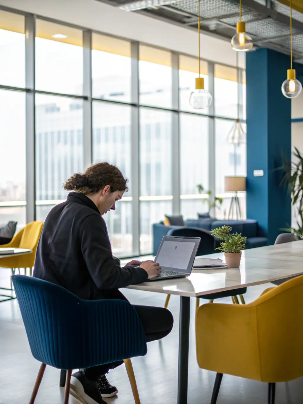 A person creating a budget on a laptop, surrounded by financial documents, representing the budgeting aspect of financial planning. The scene is well-lit and professional.